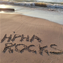 HPHA Rocks drawn in sandy beach